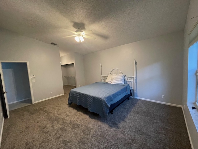 carpeted bedroom featuring a textured ceiling and ceiling fan