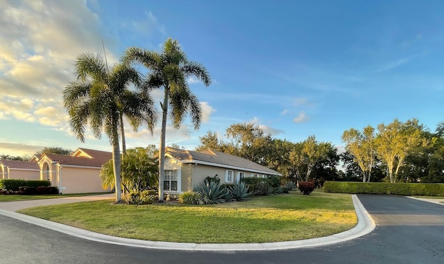 view of property exterior with a yard