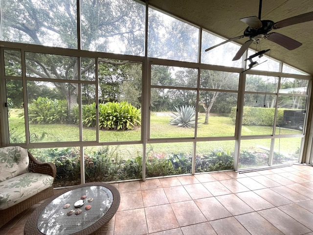 unfurnished sunroom with ceiling fan