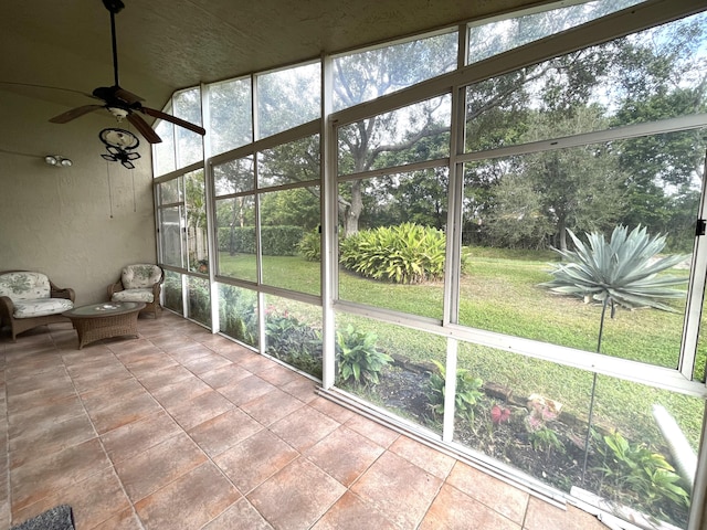 unfurnished sunroom featuring ceiling fan