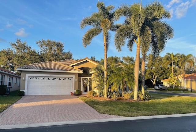 view of front of property featuring a garage and a front lawn