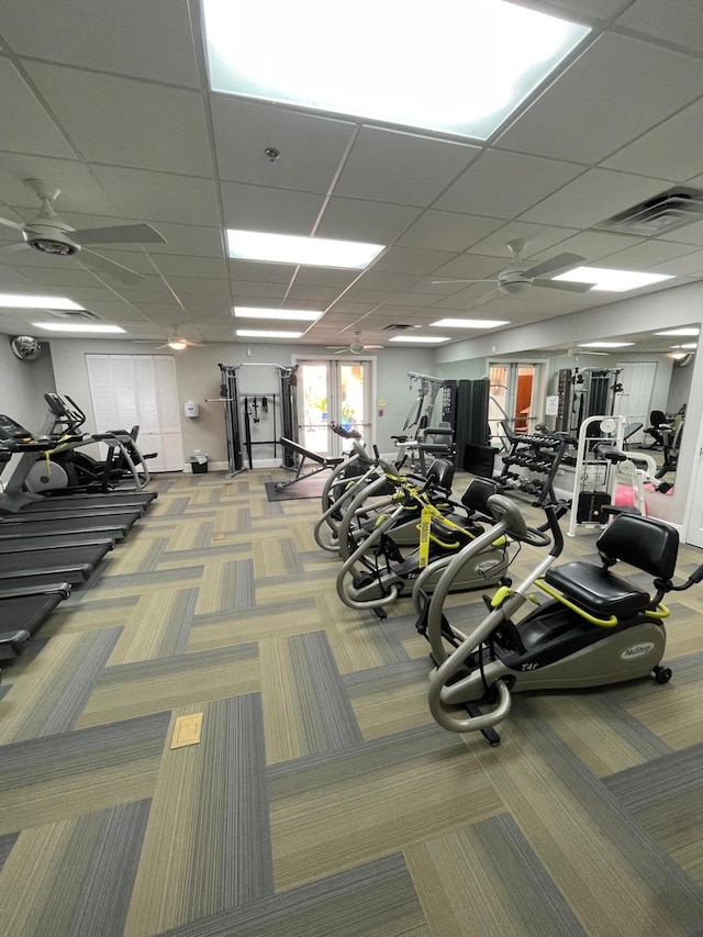 gym featuring carpet flooring and a drop ceiling