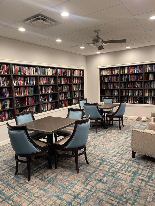 interior space featuring carpet floors and a drop ceiling