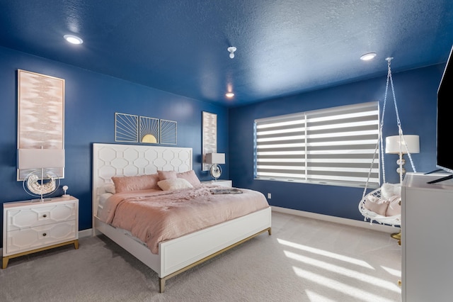 bedroom with carpet flooring and a textured ceiling