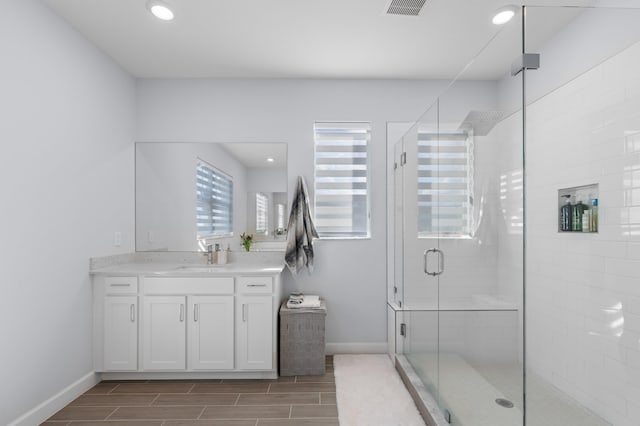 bathroom with vanity and walk in shower