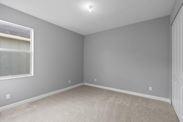 carpeted spare room with plenty of natural light