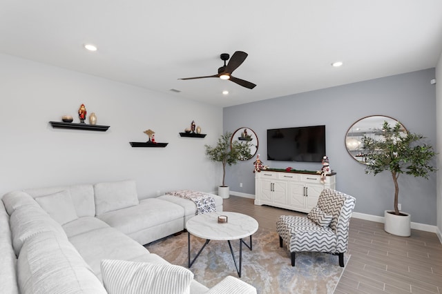 living room with ceiling fan and wood-type flooring