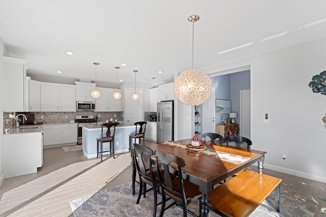 dining area with light hardwood / wood-style floors and sink