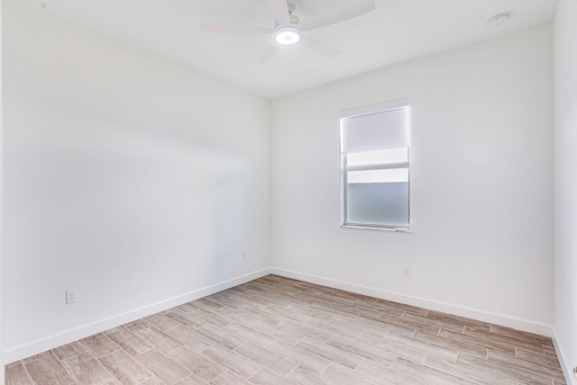 spare room with light wood-type flooring and ceiling fan