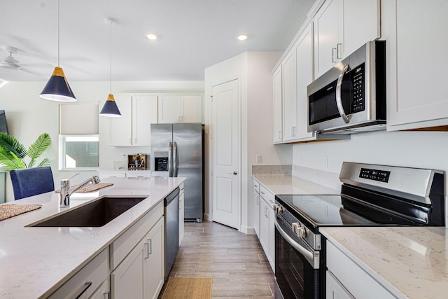 kitchen featuring white cabinetry, sink, and appliances with stainless steel finishes