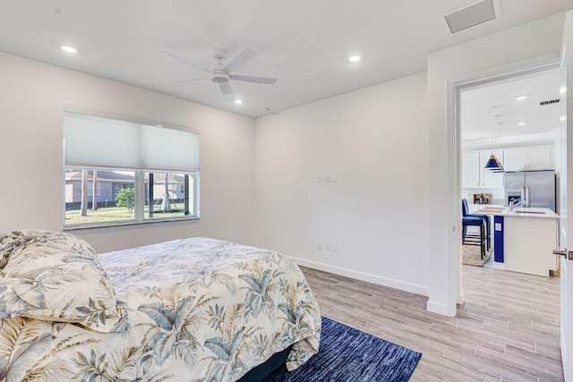 bedroom featuring ceiling fan, stainless steel fridge with ice dispenser, and light hardwood / wood-style flooring