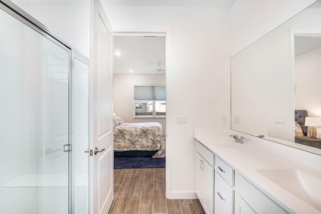 bathroom featuring vanity, an enclosed shower, and ceiling fan