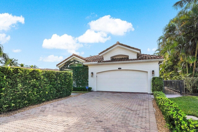 mediterranean / spanish-style house with a garage