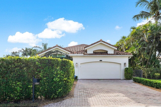 mediterranean / spanish house with a garage