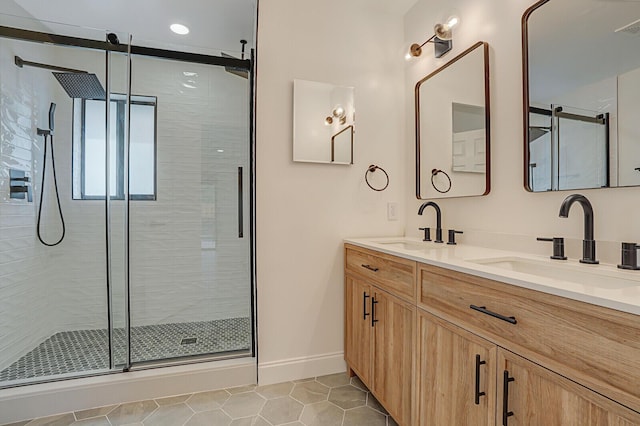 bathroom with tile patterned floors, vanity, and a shower with shower door