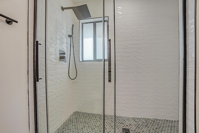 bathroom with a shower with door