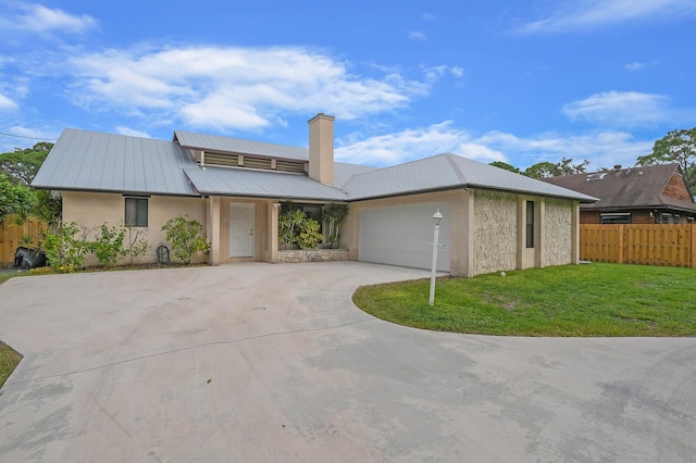 view of front of house with a garage and a front yard