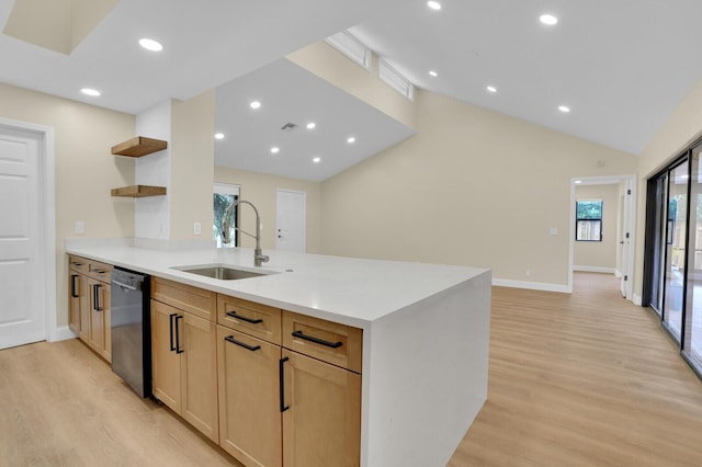 kitchen featuring dishwasher, light brown cabinets, sink, vaulted ceiling, and light wood-type flooring