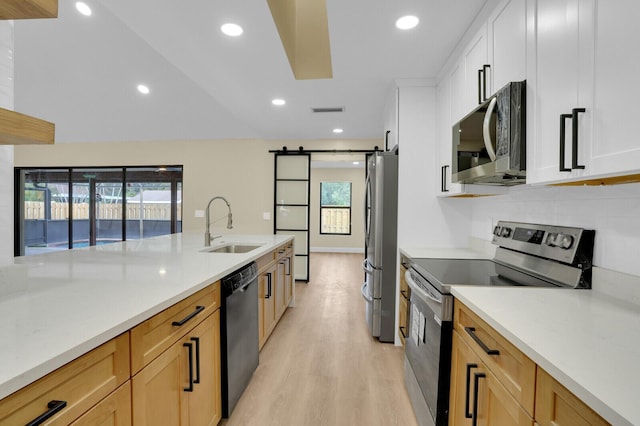 kitchen featuring plenty of natural light, sink, white cabinetry, and stainless steel appliances