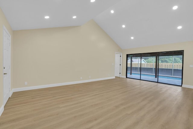 unfurnished living room featuring light wood-type flooring and high vaulted ceiling