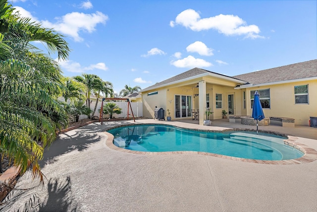 view of swimming pool with a patio area and an outdoor fire pit