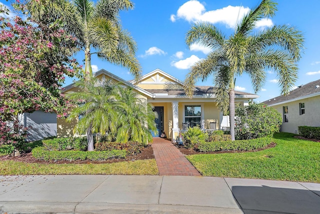 view of front of home with covered porch and a front yard