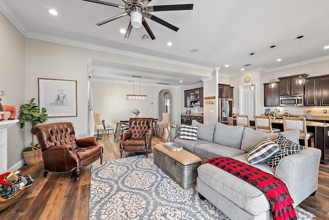 kitchen featuring a kitchen bar, stainless steel appliances, a kitchen island with sink, sink, and decorative light fixtures