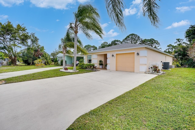 ranch-style house featuring a garage, central AC, and a front yard