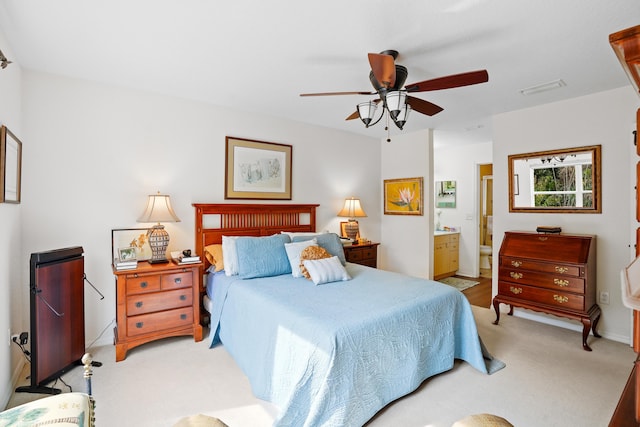 carpeted bedroom featuring ceiling fan and ensuite bathroom