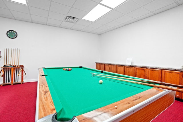 recreation room featuring carpet floors and a drop ceiling