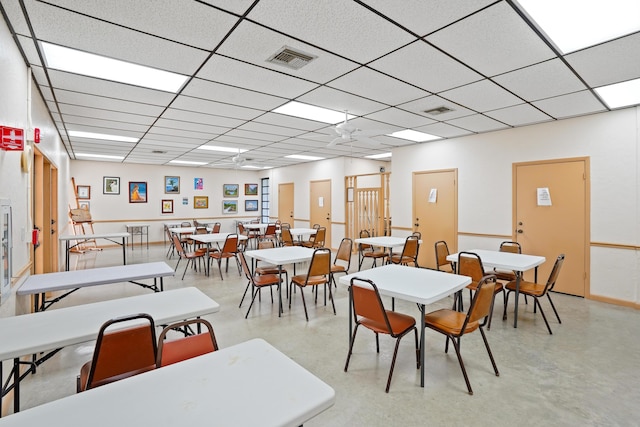 dining area featuring a drop ceiling