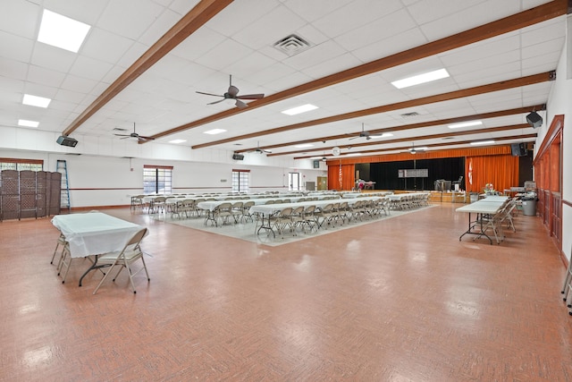 interior space with ceiling fan