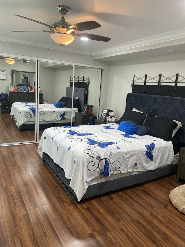 bedroom with hardwood / wood-style floors, ceiling fan, crown molding, and a closet