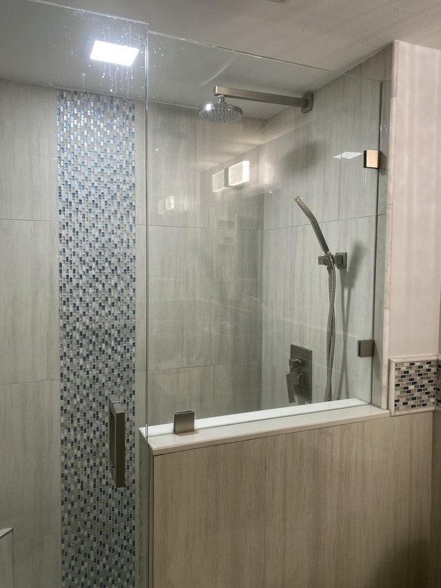 bathroom with tiled shower