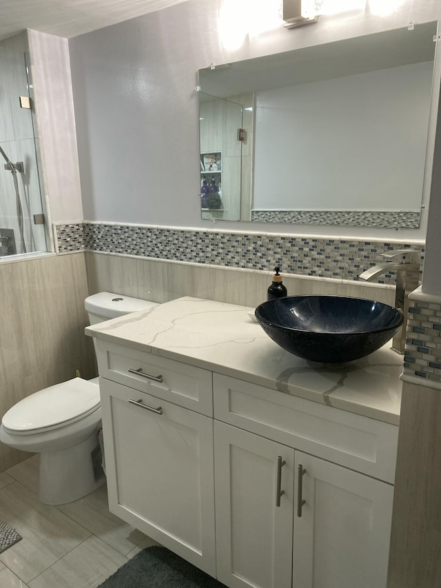 bathroom featuring vanity, toilet, and walk in shower