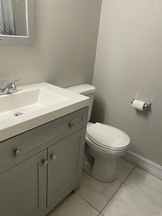 bathroom with tile patterned floors, vanity, and toilet