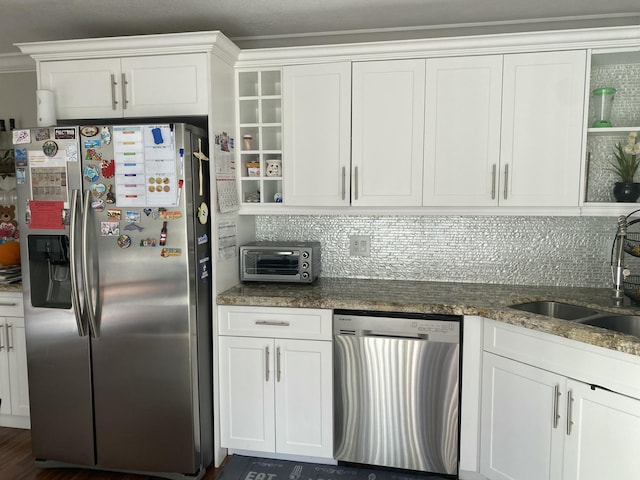 kitchen featuring white cabinetry, sink, stainless steel appliances, dark hardwood / wood-style flooring, and dark stone countertops