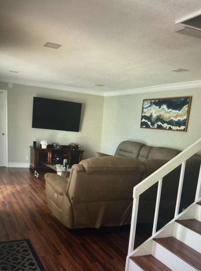 living room with a textured ceiling, dark hardwood / wood-style flooring, and crown molding