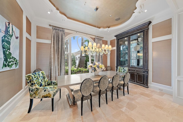 dining space with a tray ceiling and a chandelier