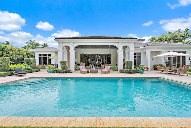 view of swimming pool featuring a patio area and ceiling fan