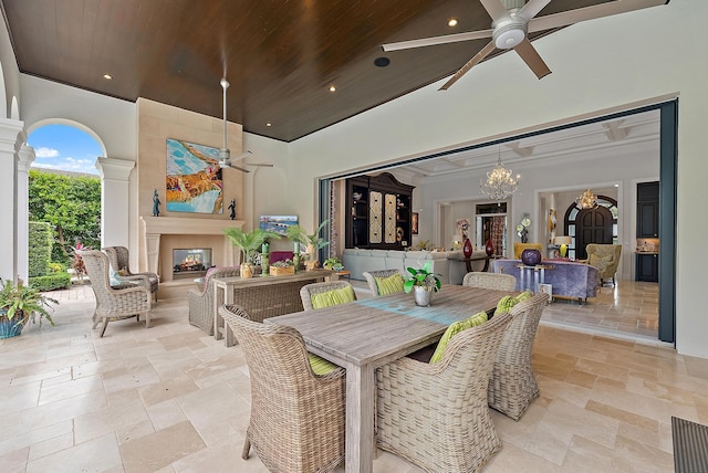 view of patio / terrace with ceiling fan and an outdoor living space with a fireplace