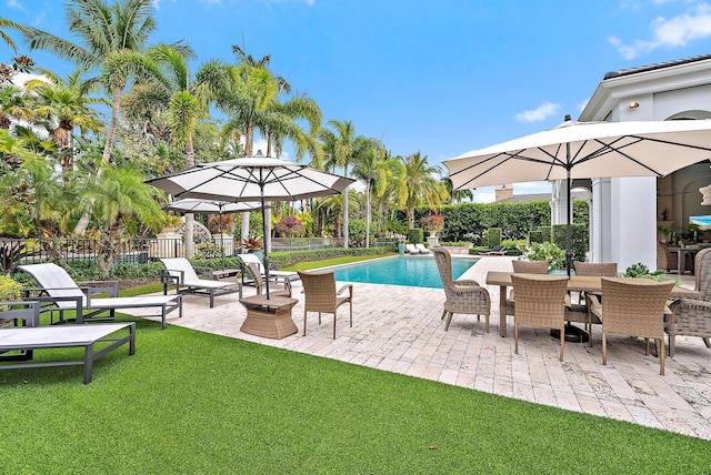 view of swimming pool featuring a patio area and a yard