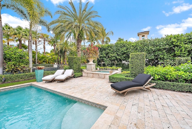 view of swimming pool with an in ground hot tub and a patio