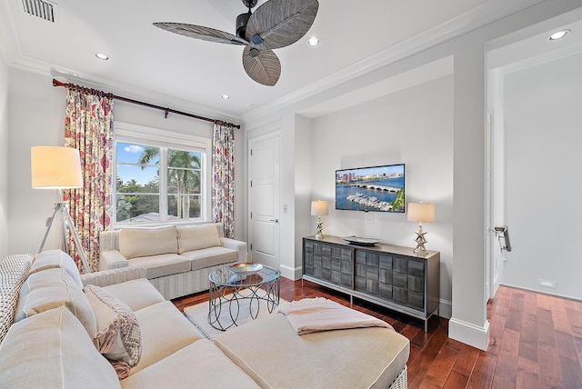 living room with ceiling fan, dark hardwood / wood-style flooring, and ornamental molding