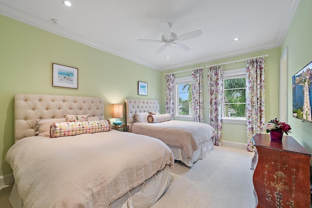 carpeted bedroom with ceiling fan and ornamental molding