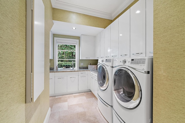 laundry room with independent washer and dryer, crown molding, and cabinets