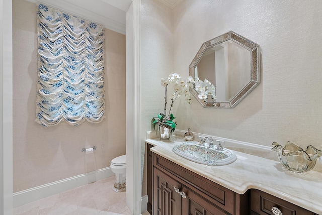 bathroom with toilet, crown molding, tile patterned floors, and vanity