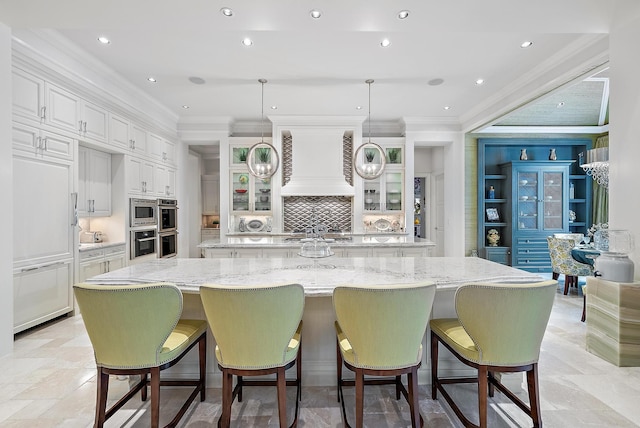 kitchen with a spacious island, pendant lighting, and a breakfast bar