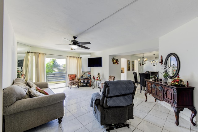 tiled living room featuring ceiling fan with notable chandelier