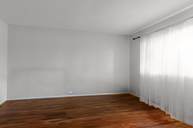 unfurnished room with dark hardwood / wood-style floors